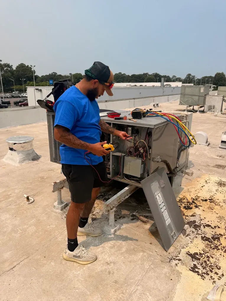 Ferguson & Sons technician diagnosing a commercial rooftop HVAC unit