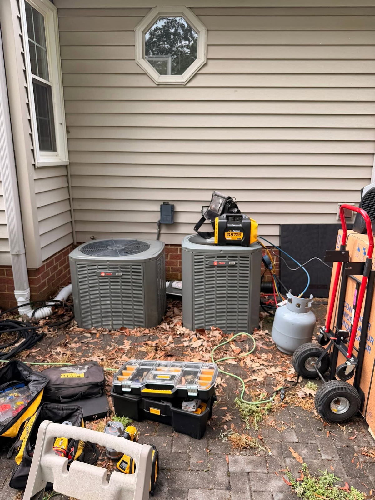 Residential outdoor HVAC units prepared for service