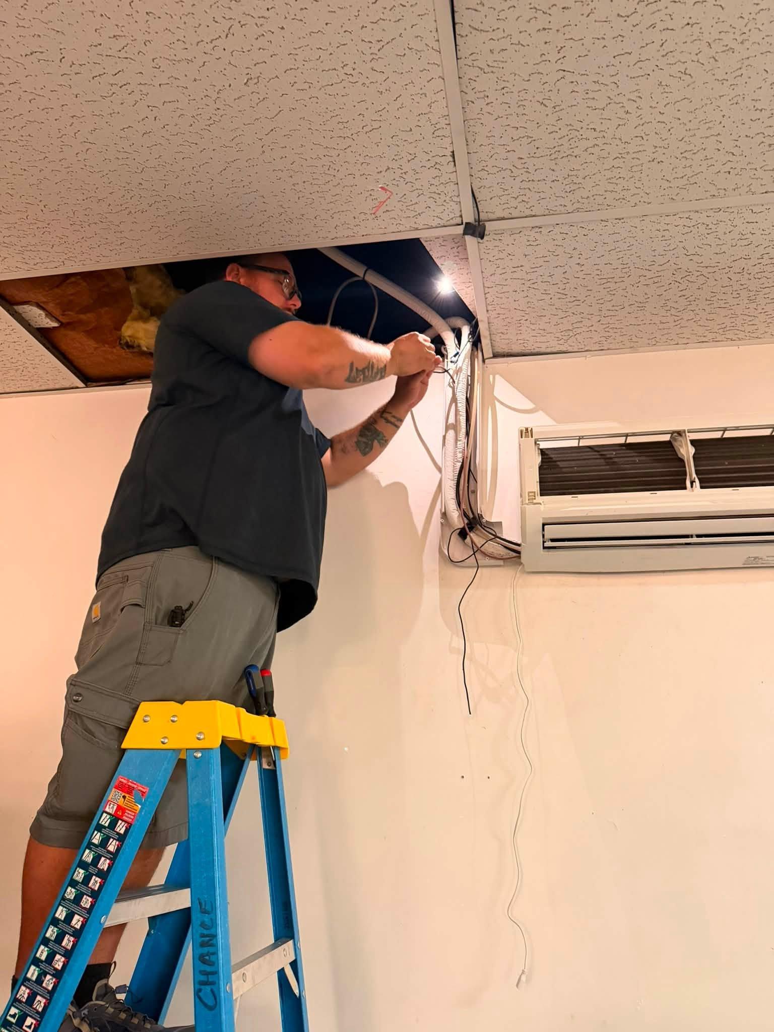 Technician installing a ductless mini-split system