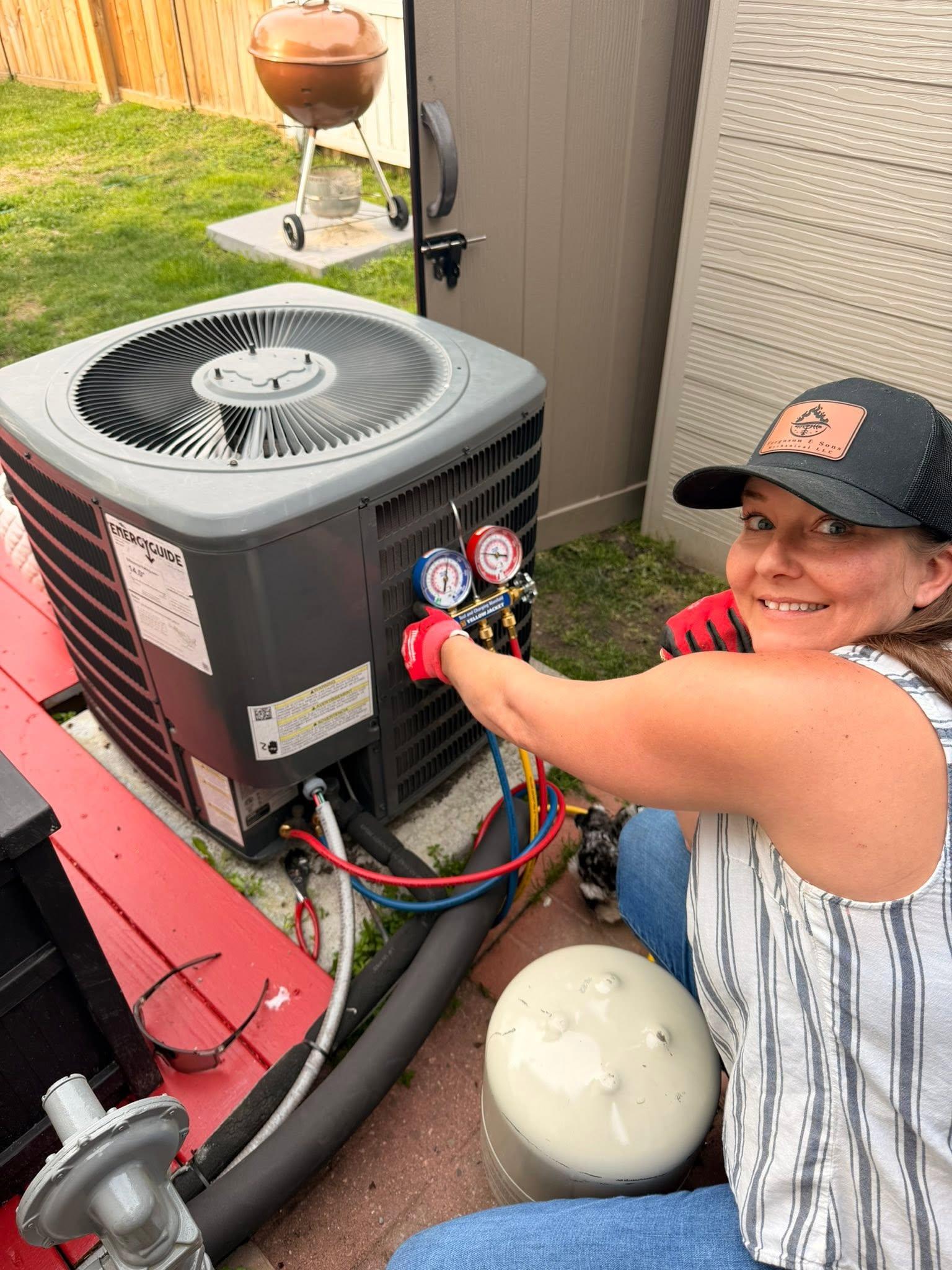 Technician servicing residential outdoor HVAC equipment