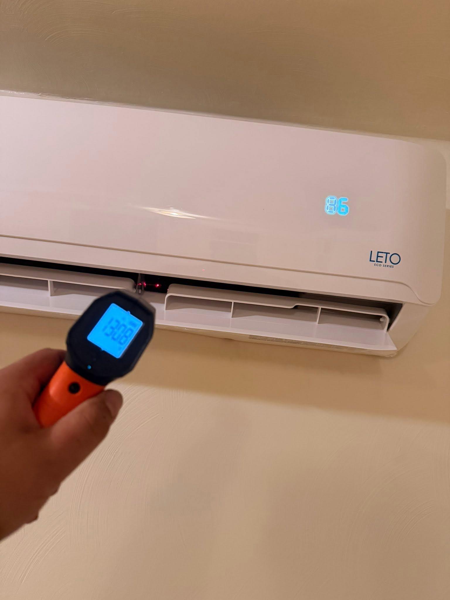 Technician checking the temperature of a ductless mini-split